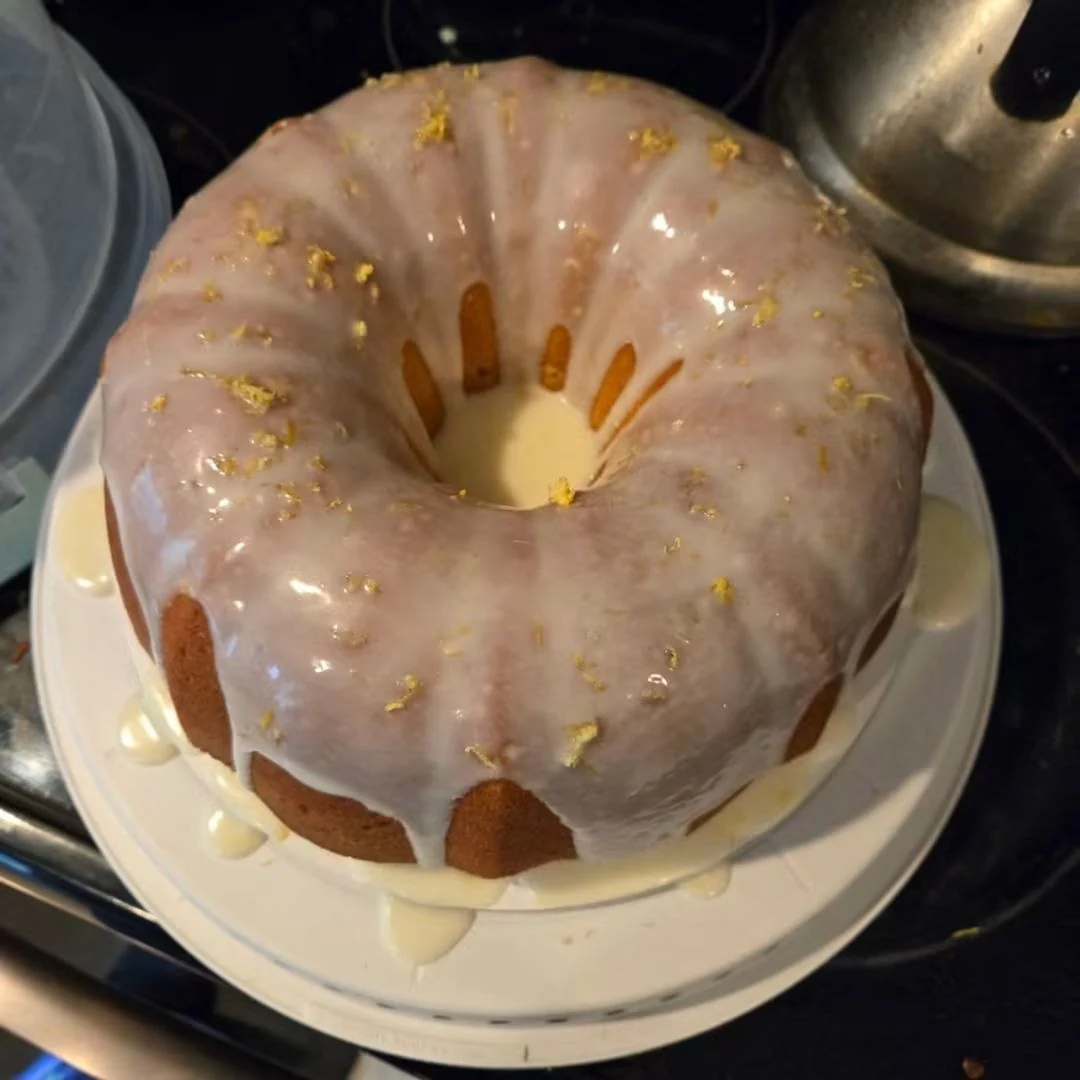 Golden Bundt cake covered in glossy pale glaze